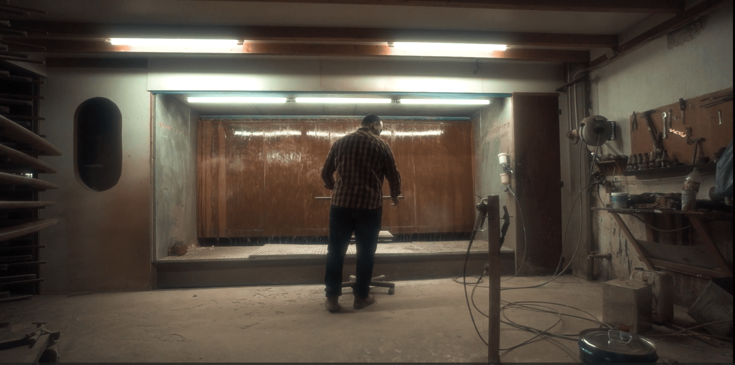 Craftsman preparing to finish a piece in the NtinosFurniture workshop